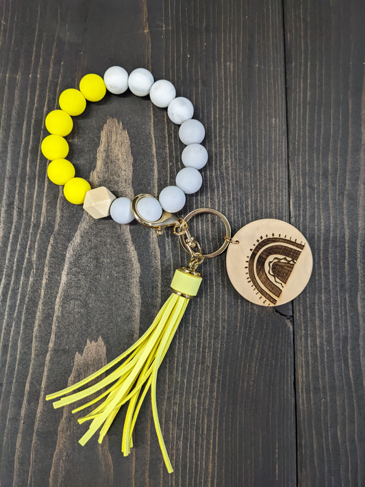 Key Chain wristlet- Yellow and grey with yellow tassels and a rainbow engraved disk