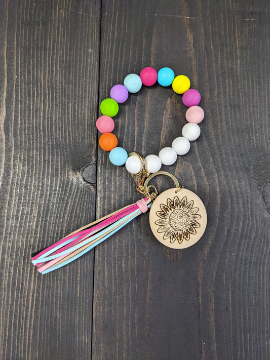 Key Chain wristlet- Multi colored wristlet and tassels with wood flower engraved disk